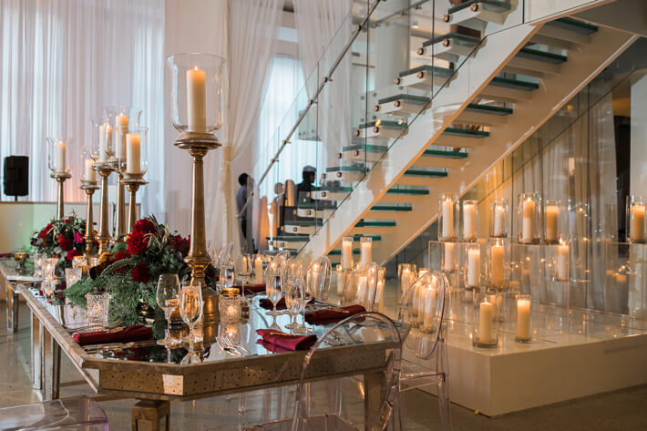 mirrored head table with burgundy detail and candles