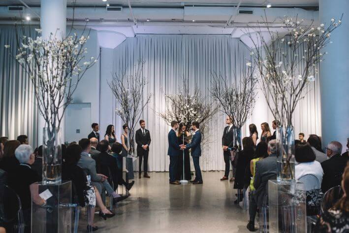 two grooms wedding ceremony tall apple blossom branches