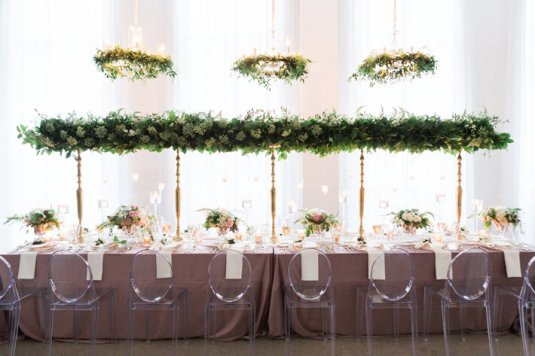 purple head table with green floral overhead table piece