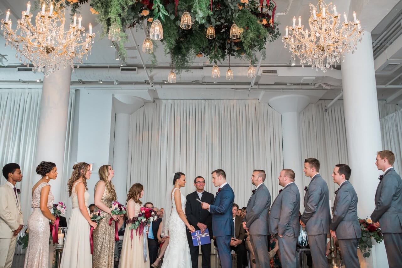 center ceremony under greenery with bridal party