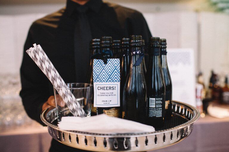 black champagne glasses with grey and white straws