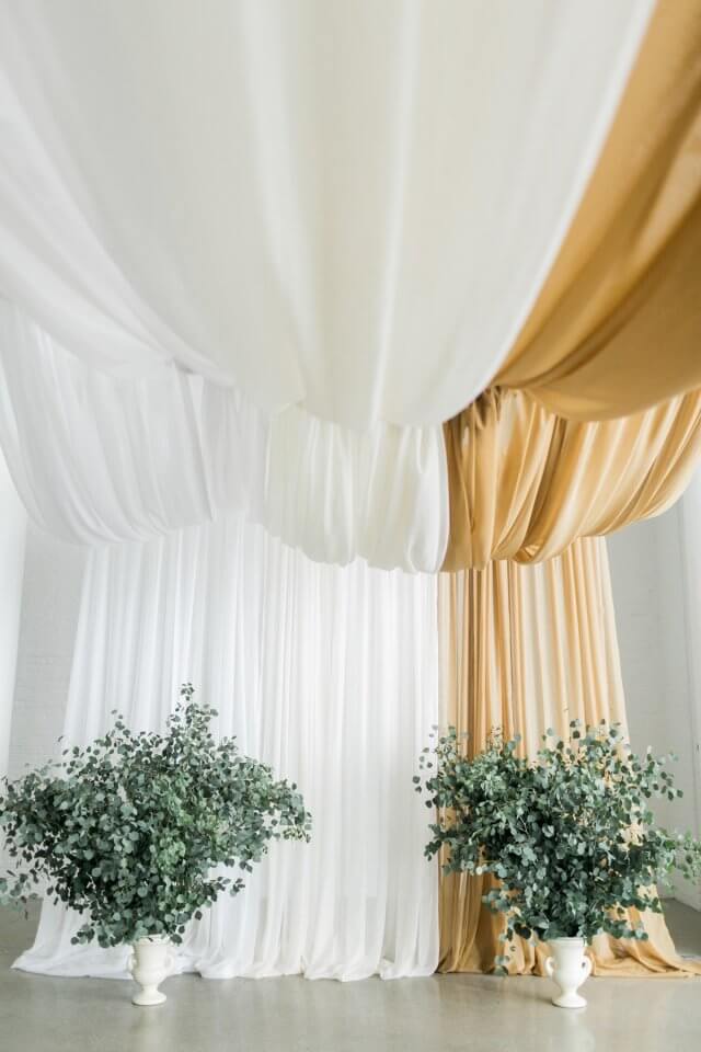 white and gold ceremony backdrop draping
