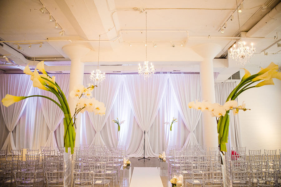 bright white and silver wedding ceremony with orchids and lillys