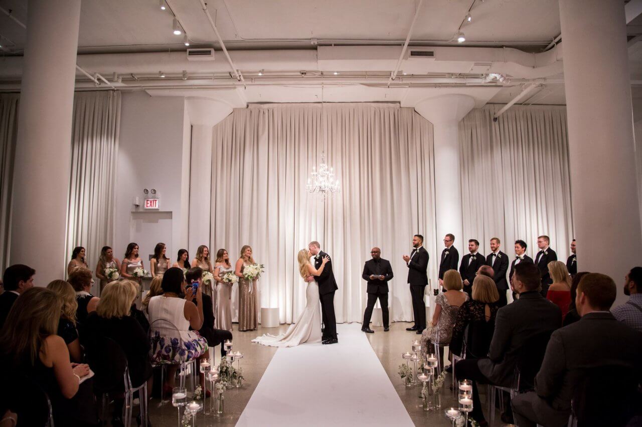 white and silver glamorous chandelier wedding ceremony