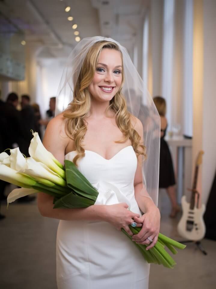 photo of bride holding large green and white flowers