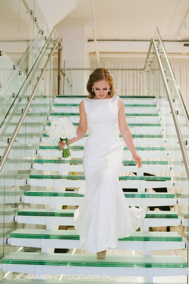 bride walking doen chez wedding venue glass stairs