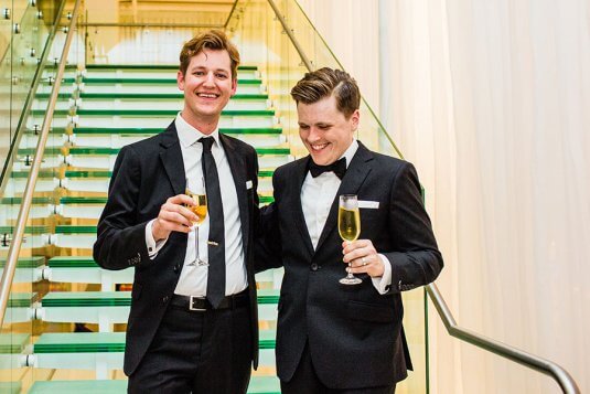 grooms walk down chez staircase and toast with champagne