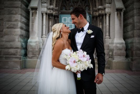 summer wedding bride and groom out front of church