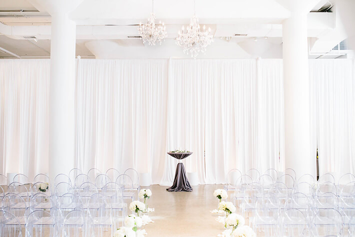 bright white wedding ceremony with grey cocktail table