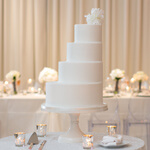 modern white wedding cake on sequin table linen at chez wedding venue