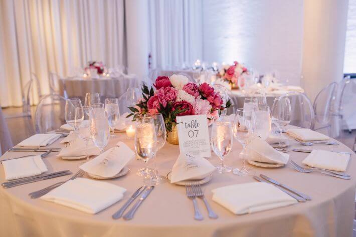 white round table with pink peonies as centerpiece