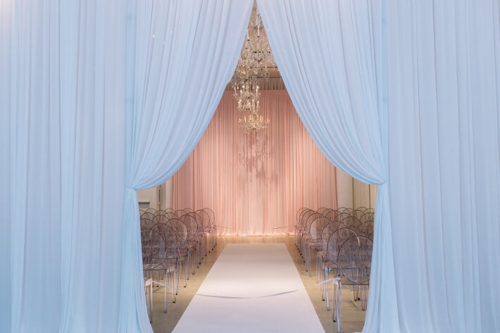 chandeliers and pink backdrop at chicago wedding ceremony