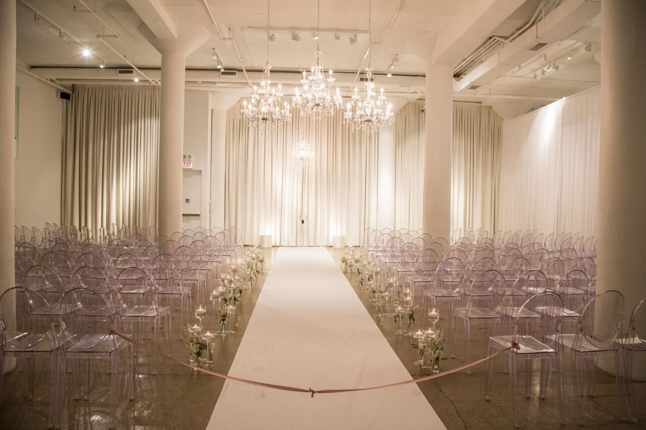 white chandelier ceremony in white modern space