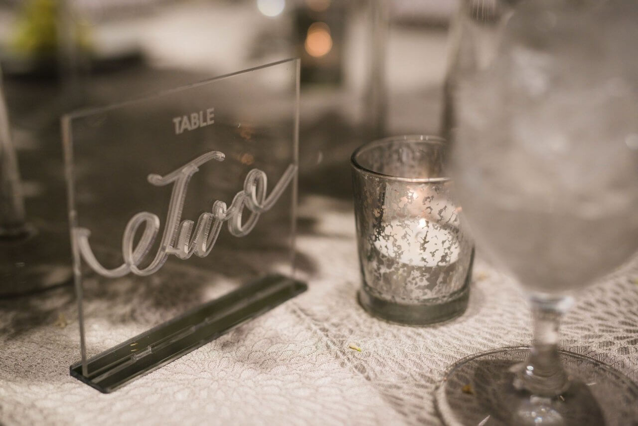 silver and clear table numbers on silver tablecloth