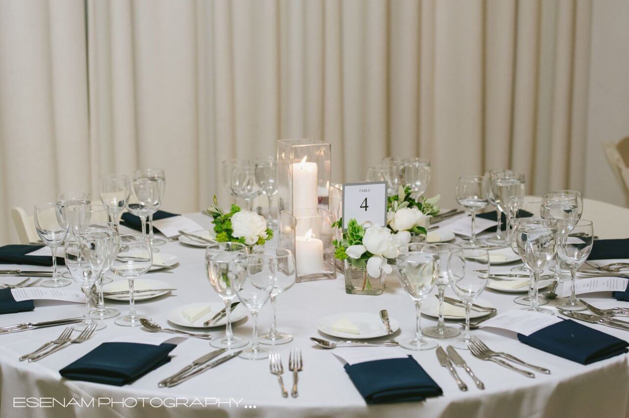 white table with navy napkins and lucid candles
