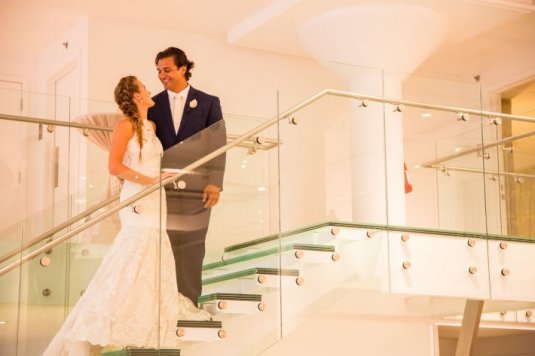 bride and groom on the top of chez wedding venue stairs