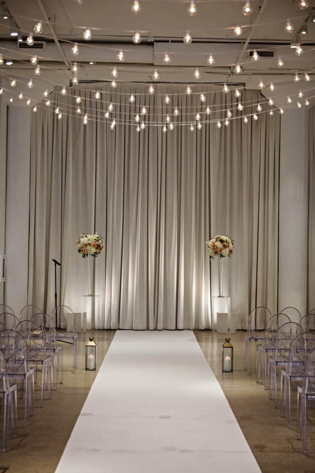 sting light ceremony with tall flower centerpieces
