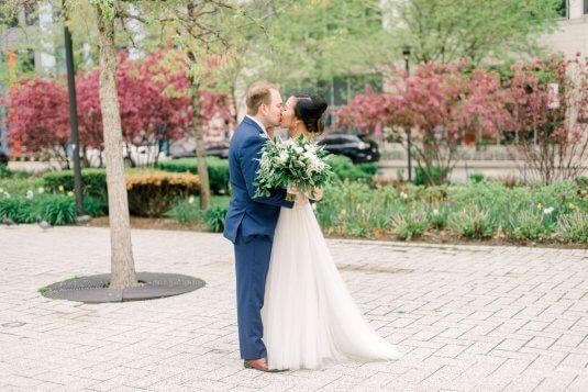 bride and groom kiss on patio