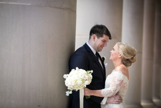 bride and groom smile at each other