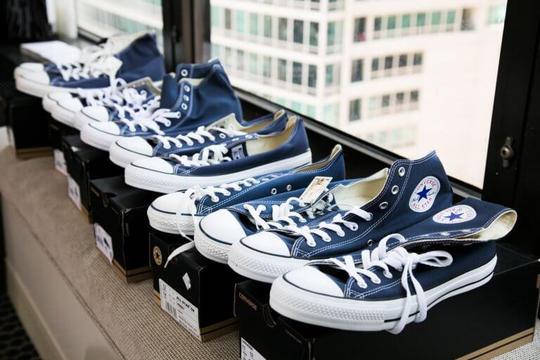 navy converese lined up agansit window
