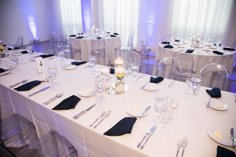 white reception table with navy napkins