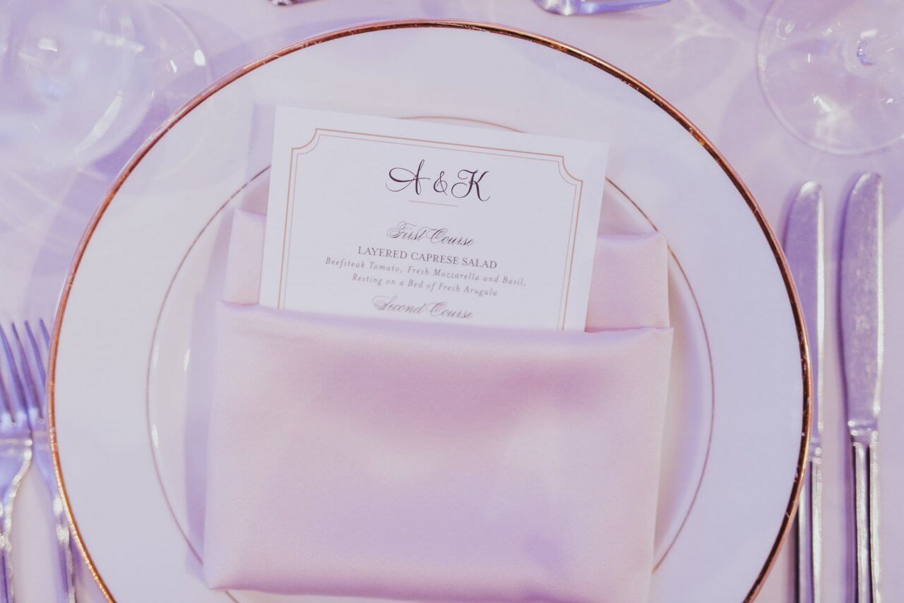 white and gold place setting with custom menu card