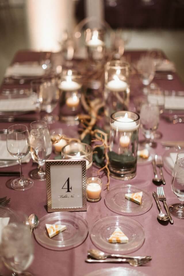 branch centerpieces on purple table