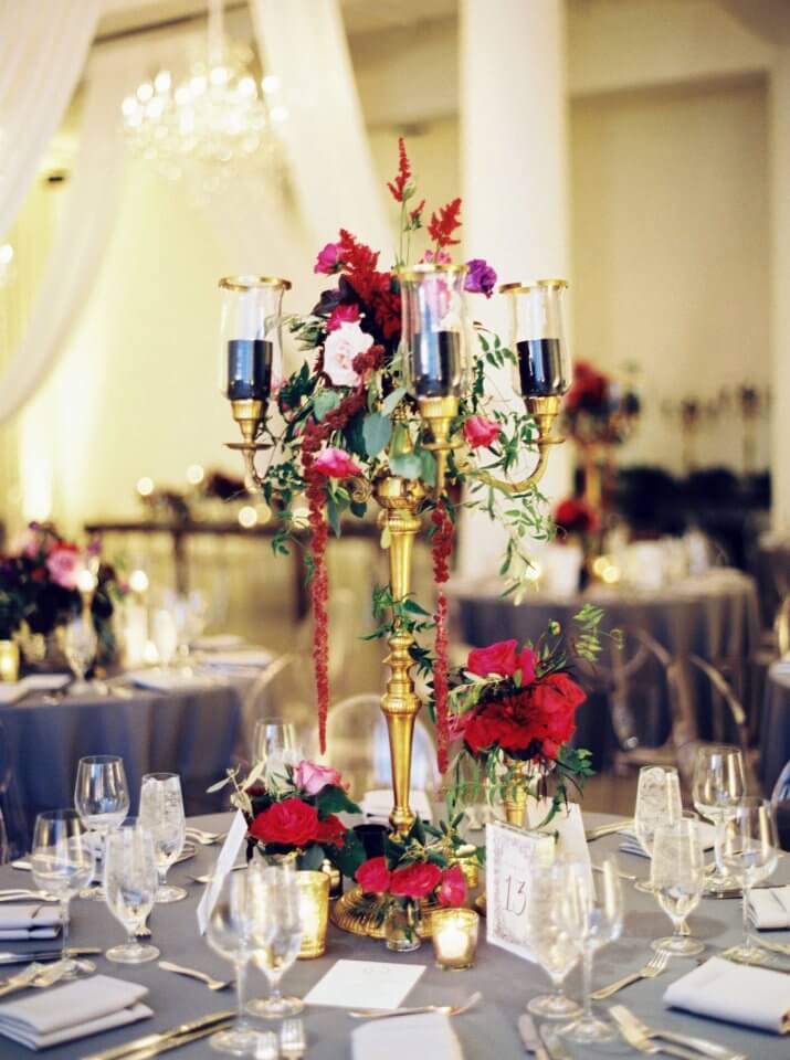 gold candle centerpiece on grey tablecloth