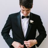 male model in tuxedo looking down