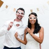 couple holding props for photobooth