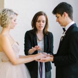 bride and groom ribbon tying at alter