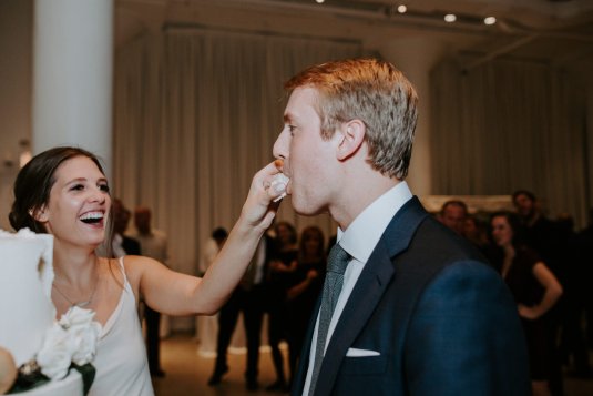 bride feeding cake to groom