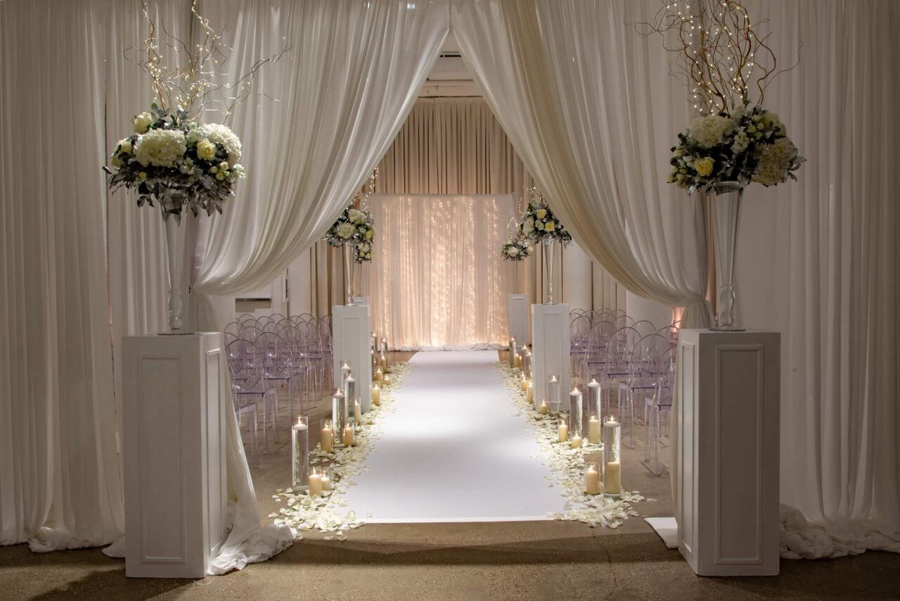 wedding drapery to wedding isle with candles and flowers