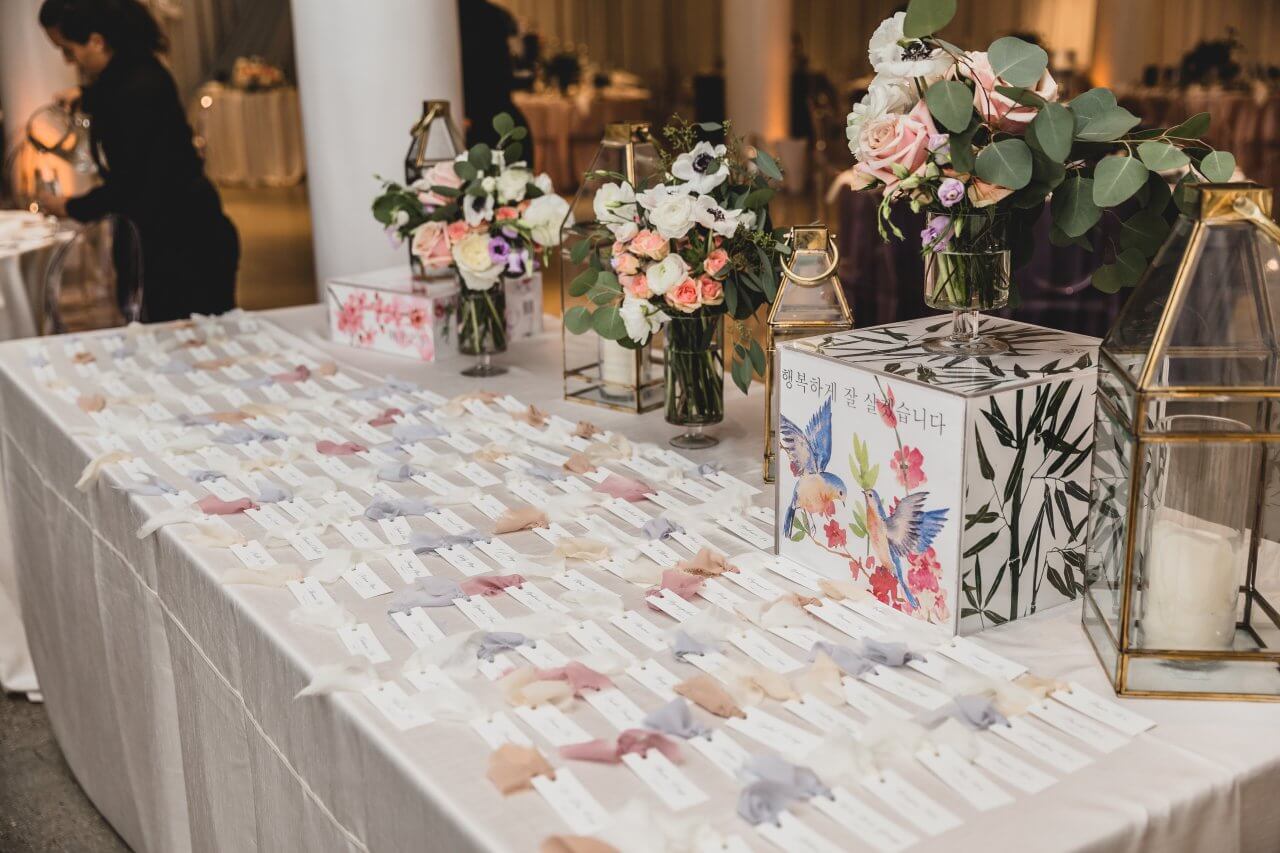 wedding escort card table with colorful tags and korean hummingbird box