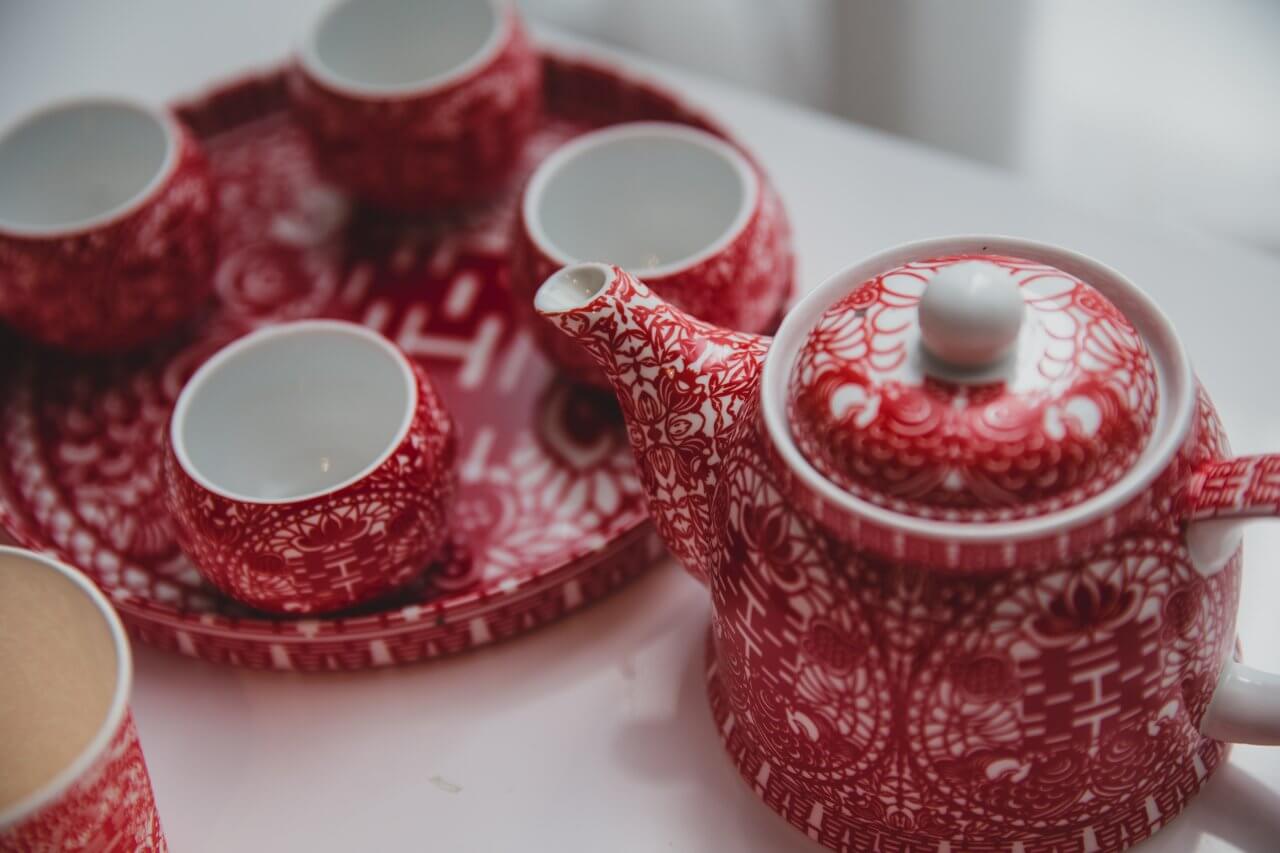 red and white tea pot and tray