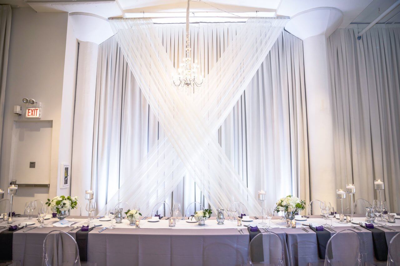 purple head table with white draping