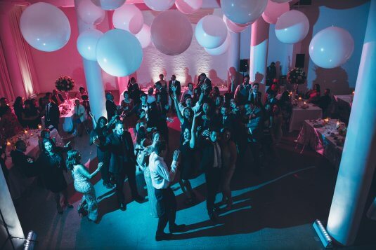 group of wedding guests dancing in downtown Chicago wedding venue Chez